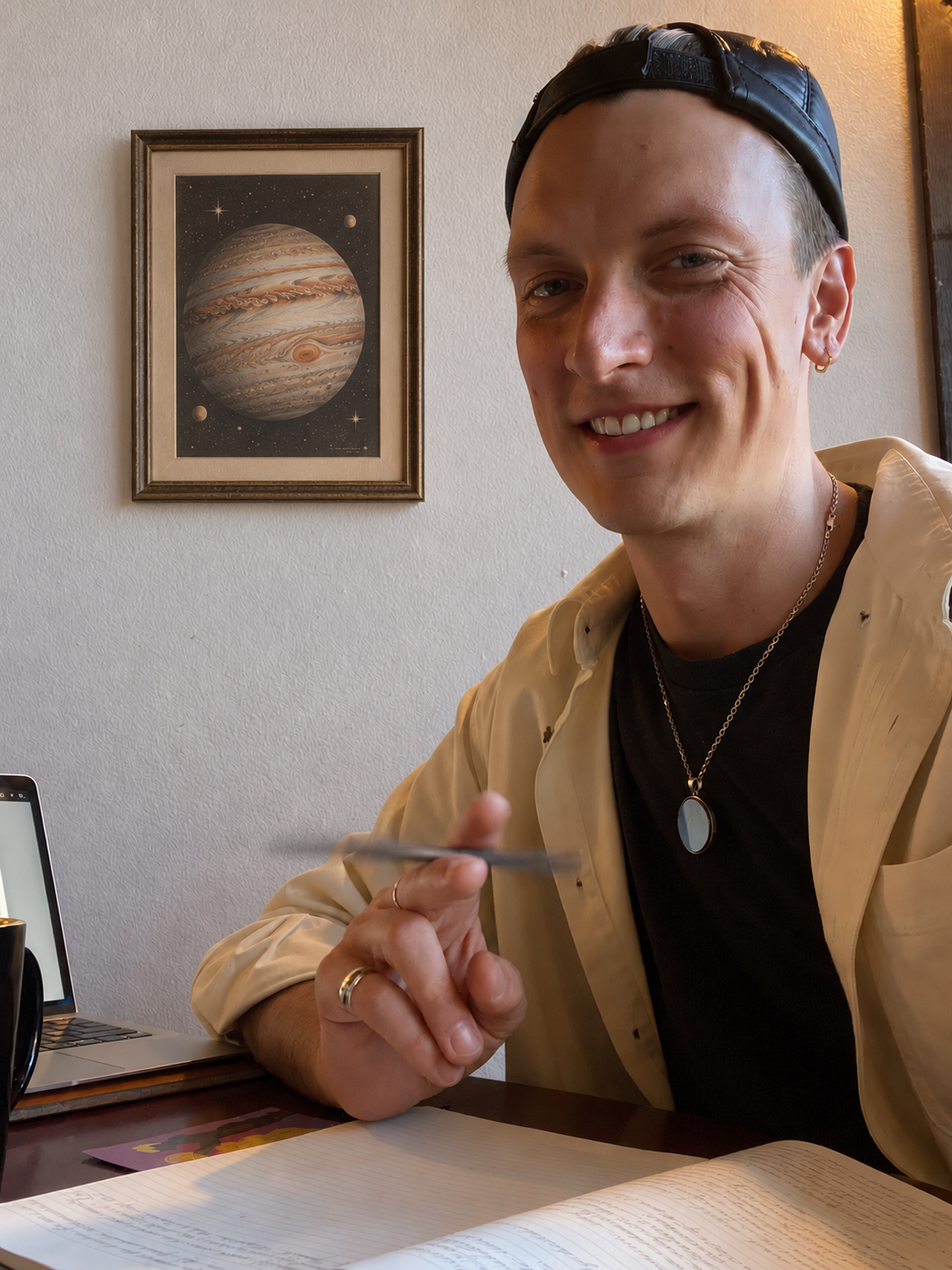 Austin seated at a desk with a framed Jupiter image behind him